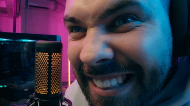Astonished shocked Caucasian vlogger guy male laugh blogger influencer close up surprised man gaming addicted male streamer play cyber sport online game pc computer neon amazement wow emotion at home photo