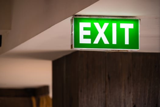 Safety Exit Sign with Green Illumination in Contemporary Building photo