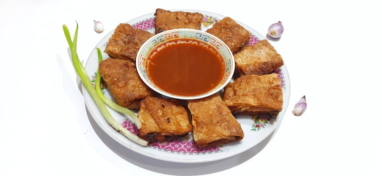 Martabak telur or Martabak telor. Savory pan fried pastry stuffed with egg, meat and spices served with sauce, Indonesian street food photo