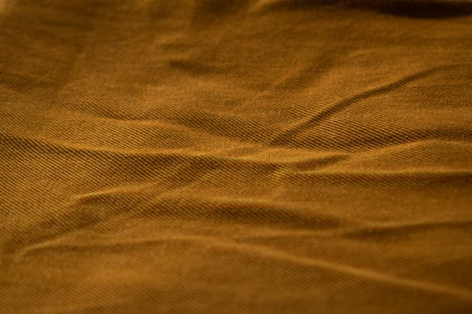 Detailed close up bright brown jeans fabric background texture. photo