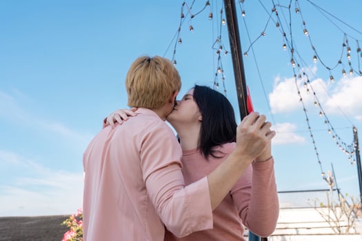 Valentine couple embracing under twinkling lights rooftop romantic moment clear sky intimate viewpoint photo