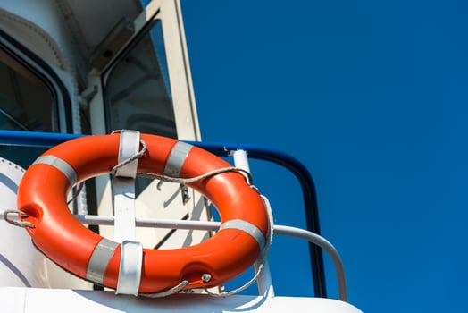 Orange lifebuoy on a white yacht photo