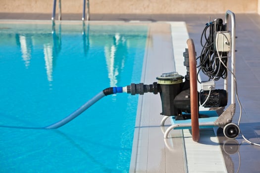 Cleaning pump working with a swimming pool photo
