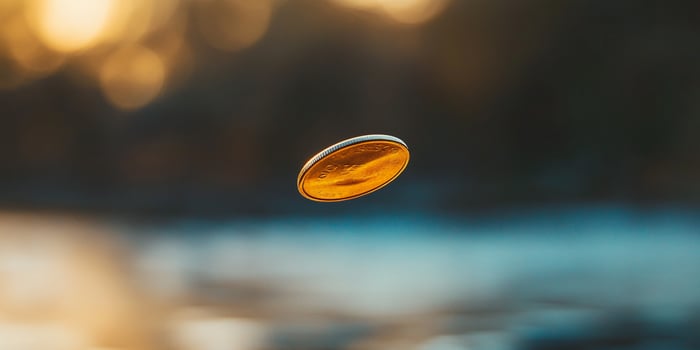 Single Coin Tossed in Mid-Air with Blurred Background photo