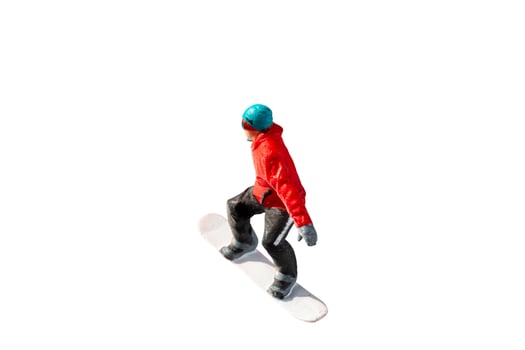 Miniature figurine depicting a snowboarder in mid-motion isolate on white background with clipping path photo