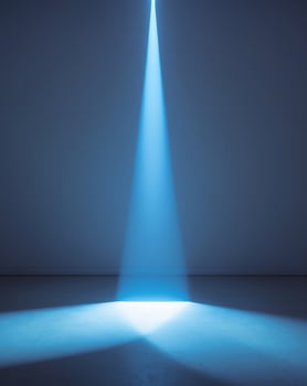 A spotlight shines brightly in a dark room photo
