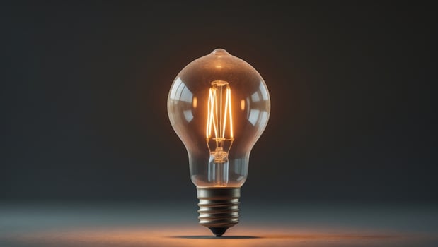 Glowing vintage light bulb illuminating dark background photo