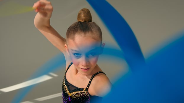 Little girl child kid daughter Caucasian schoolgirl young athlete teenager sport gymnast artistic female ballet dancer sportswoman perform swirling spinning gymnastic tape dance studio choreography photo