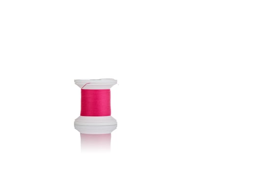 skein of thread pink colors macro on a white background photo