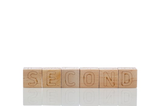 Wooden cubes with letters second on a white background photo