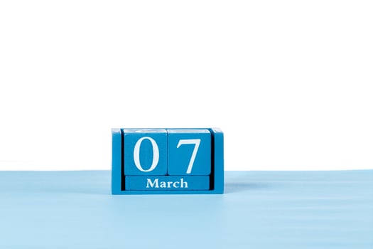 Wooden calendar March 07 on a white background photo