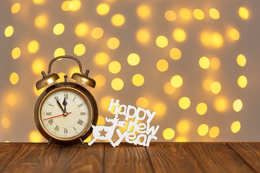 clock and the inscription Happy New Year on the background of blurry lights photo