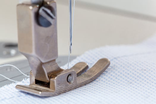 Sewing machine needle with thread and fabric photo