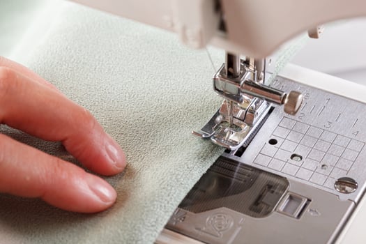 Sewing machine, stitching fabrics, needle in a round plan photo
