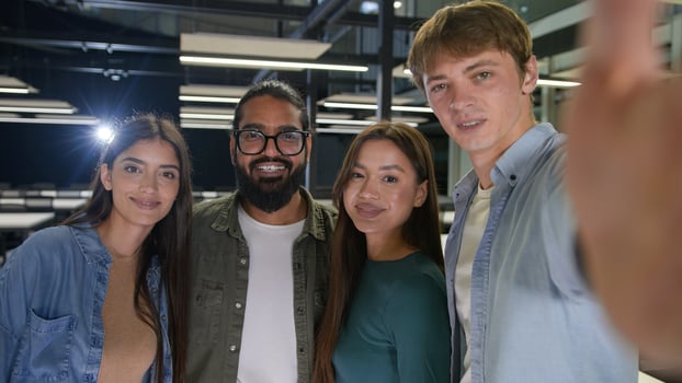 Happy multiracial friends group multinational diversity people women men students girls guys business colleagues friendship posing together in office smiling laughing for selfie photo on mobile phone