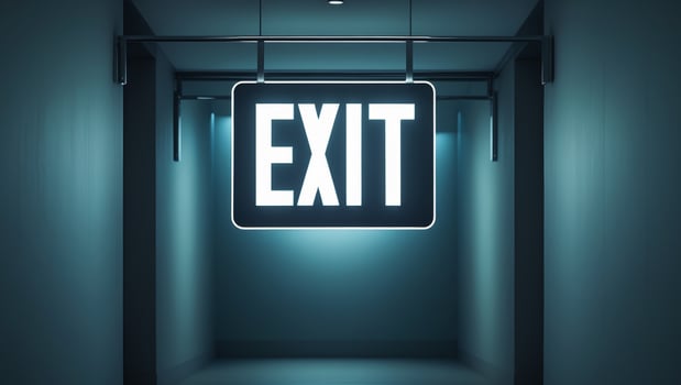 Illuminated exit sign with brackets in dark hallway photo
