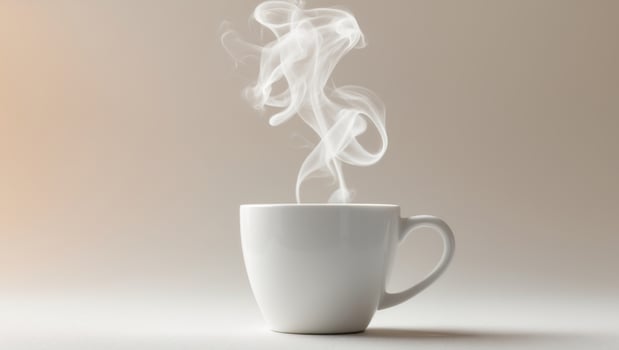 White coffee cup with steam coming out of it photo