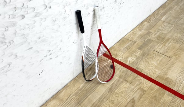Squash rackets and ball on court floor, top view photo