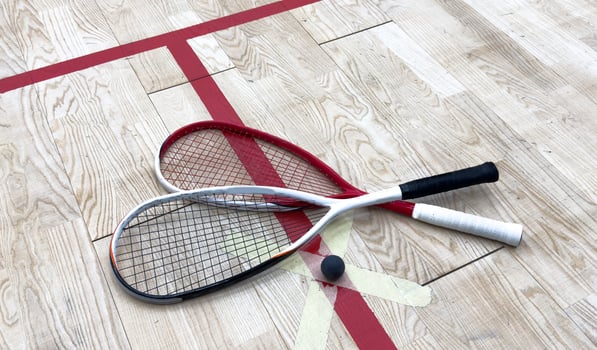 Empty squash court and rackets on the wooden floor. photo