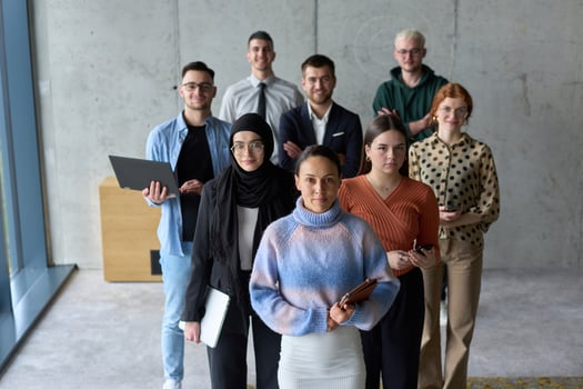 A diverse and determined team of business professionals stands confidently in an office, ready to tackle new business plans and challenges with a focus on success and growth photo