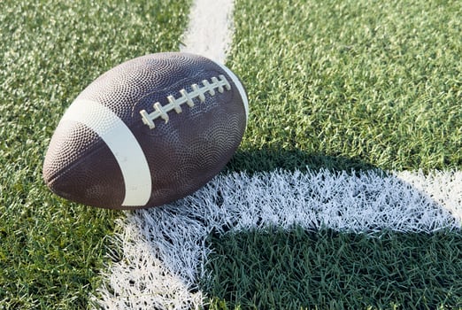 American football on green grass background. Team sport concept photo