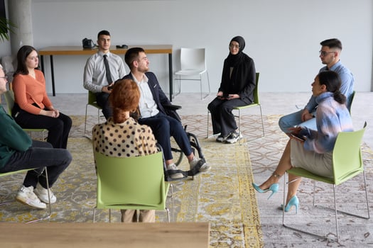 Corporate business team meeting with a manager or coach. Group of happy diverse, multiracial people sitting in a circle photo