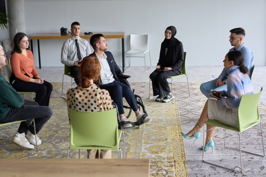 Corporate business team meeting with a manager or coach. Group of happy diverse, multiracial people sitting in a circle photo