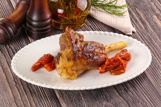Baked lamb shank with vegetables photo