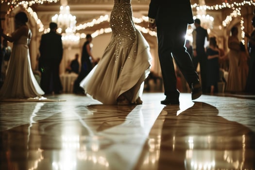 A bride and groom dancing in a ballroom photo