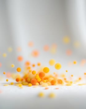 Blurry image of a bunch of bright orange and yellow dots photo