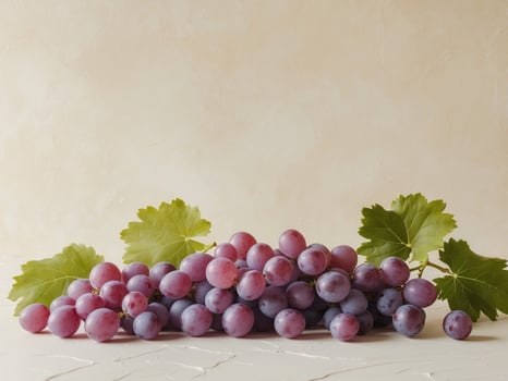 Fresh Purple Grapes with Green Leaves on Pale Background for Healthy Lifestyle and Dietary Concepts photo