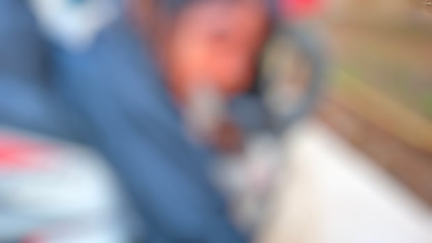A blurry image of a person sitting on a motorcycle photo
