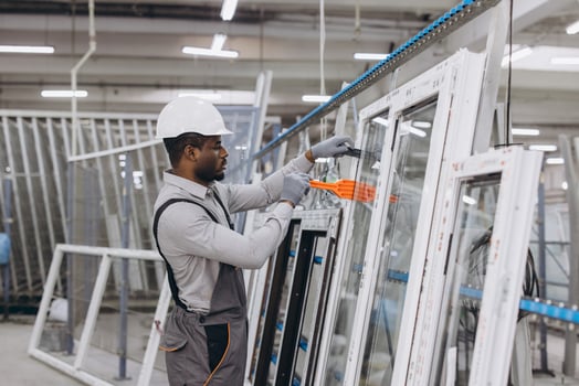 Factory worker assembling aluminum and PVC windows and doors photo