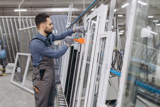 Factory worker assembling aluminum and pvc windows and doors photo