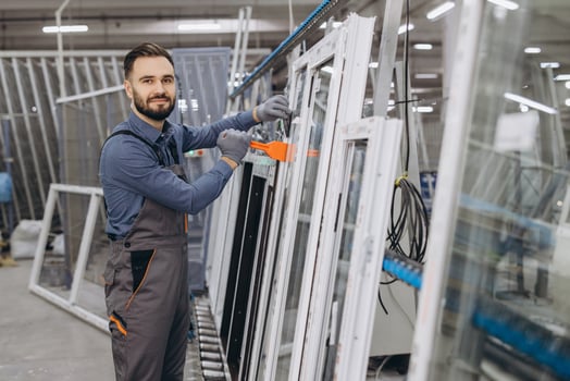 Factory worker assembling aluminum and pvc windows and doors photo