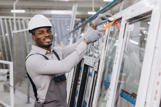 Factory worker assembling aluminum and pvc windows and doors photo