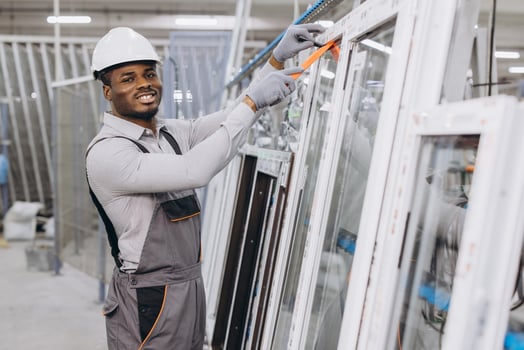 Factory worker assembling aluminum and pvc windows and doors photo