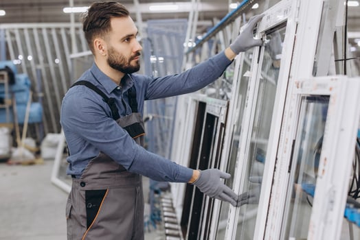 Factory worker checking aluminum and pvc windows and doors production photo