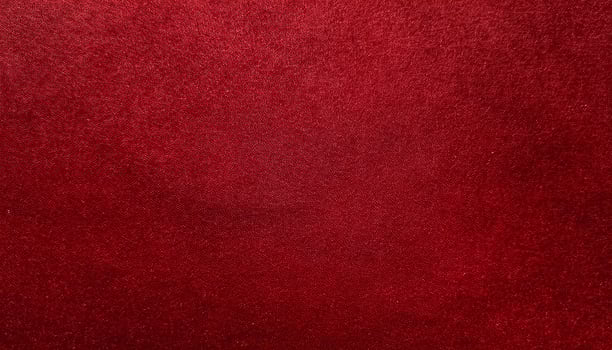 close-up of luxurious red velvet-finished paper with soft tactile texture and deep color photo