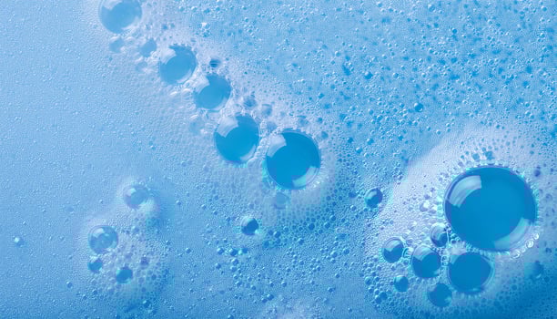 macro view of delicate blue cleanser foam with evenly sized micro-bubbles and smooth texture photo