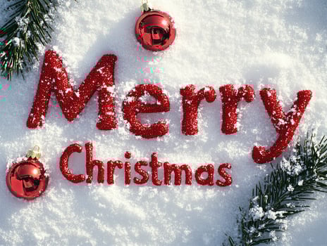 Merry Christmas is written in red letters on a snowy surface photo