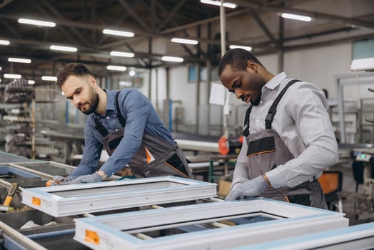 Factory workers assembling PVC windows in production line photo