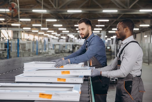 Factory Workers Handling PVC Window Frames on Assembly Line photo