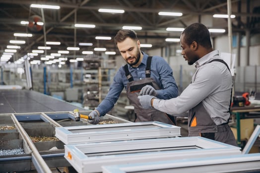 Factory workers assembling pvc window frames on production line photo
