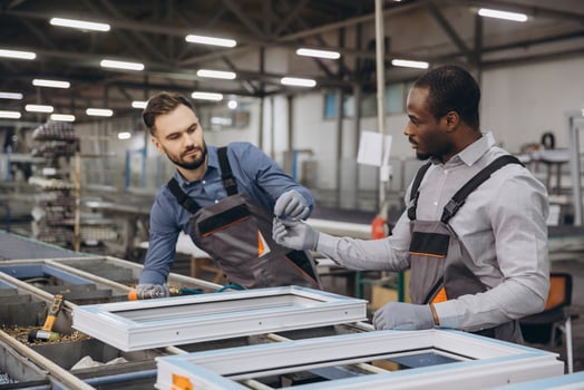Factory workers assembling PVC windows in production line photo