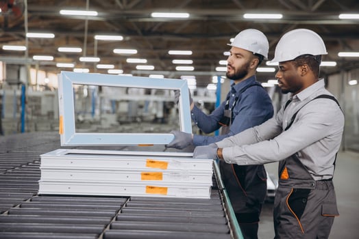 Factory workers assembling pvc windows in production line photo