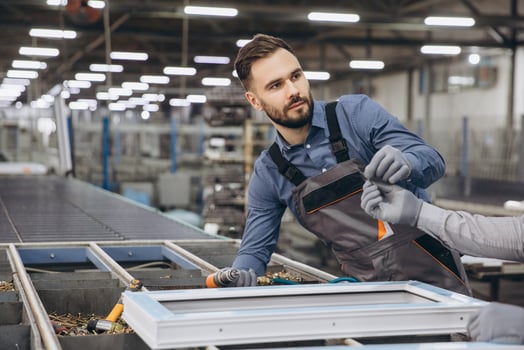 Factory workers assembling aluminum and PVC window frames on production line photo