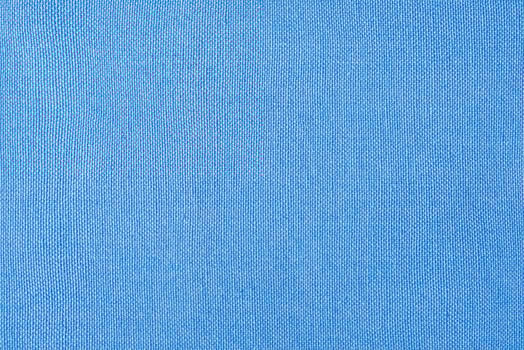 Light blue fabric as a background macro photo. Blue background photo