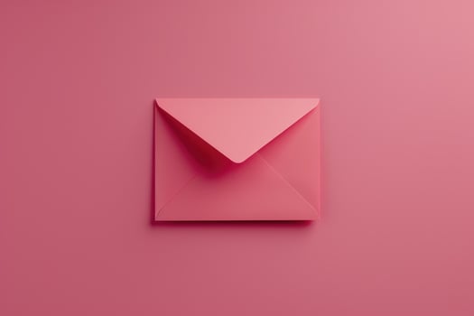 An open pink envelope on a pink background photo