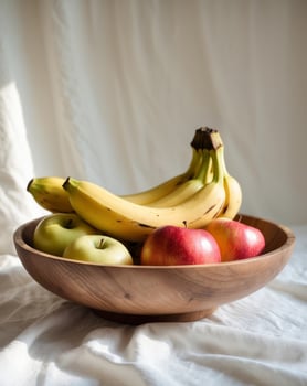 A wooden bowl with bananas and apples photo